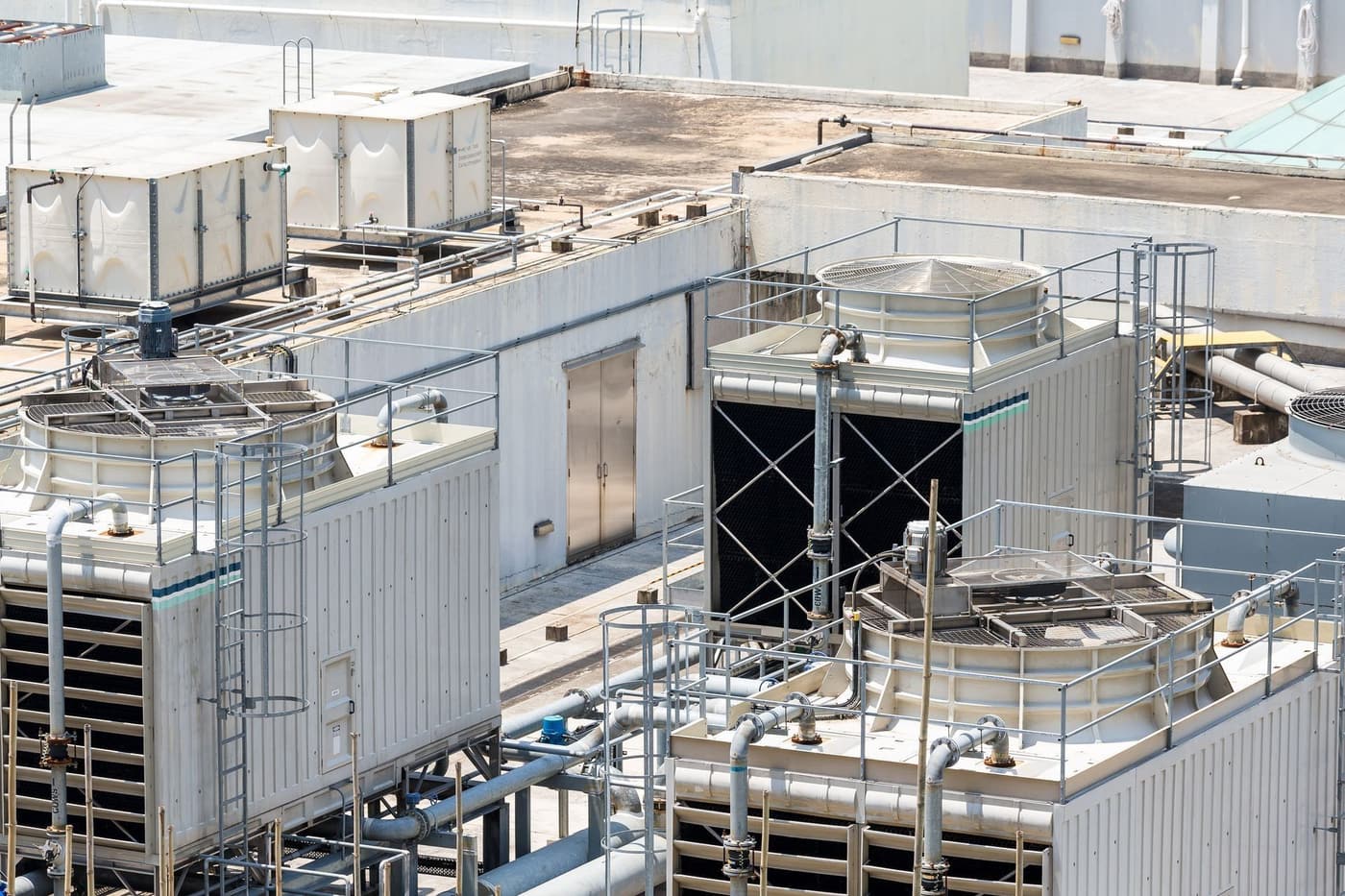 Commercial rooftop air conditioning units and cooling towers seen from above