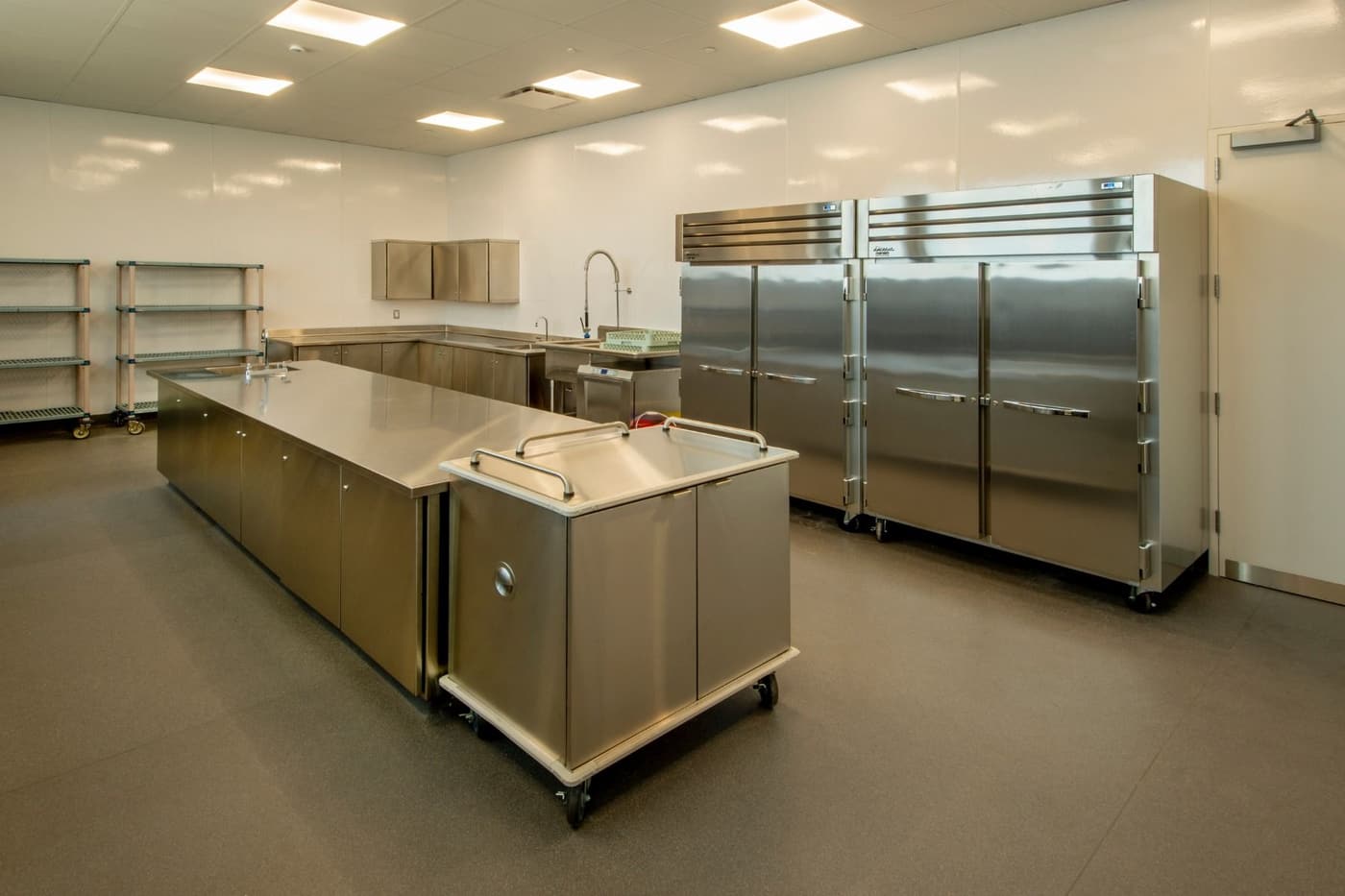 A large kitchen with a lot of stainless steel appliances