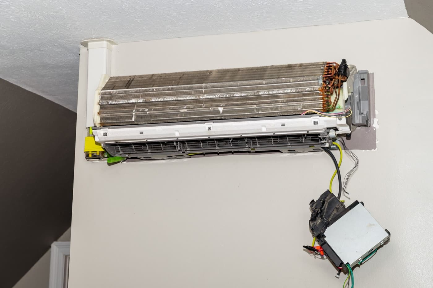 Close-up of a ductless AC evaporator coil with the cover removed for service