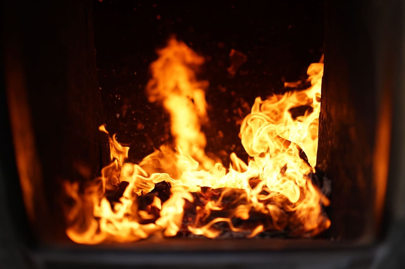 Close-up of flames burning inside a furnace combustion chamber